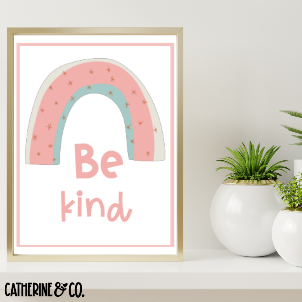 Be Kind inspirational framed poster sitting on table.